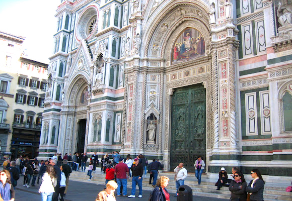 Panels of green, pink, and white marble decorate the Duomo
